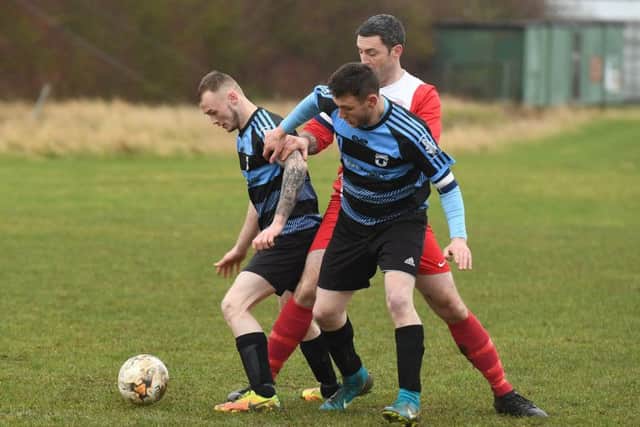 Leverton Res (blue) v Digby FC (red). Kris Holland and Aaron Smith (blue), Jason David (red).