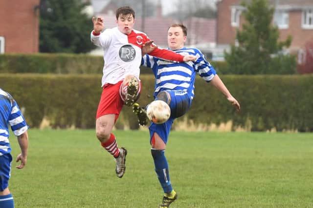 Benington (blue) v Skegness Town Res (red). Josh Meadows (blue), Devon Ainscow (red).