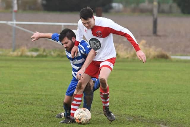 Benington (blue) v Skegness Town Res (red). Jamie Lawson (blue), Corran Pendrigh (red).