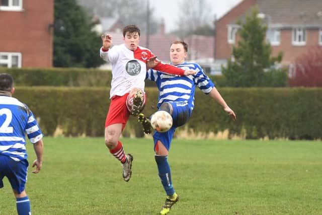 Benington (blue) v Skegness Town Res (red). Josh Meadows (blue), Devon Ainscow (red).