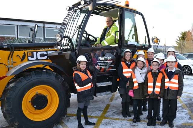 Chloe Betmead, of Bardney church of England and Methodist School, meets the telehandler Norman she named as part of Chestnut Homes competition. EMN-180122-161012001