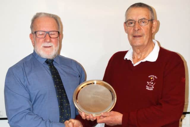 Bill Laing (right) presenting the 2017 captain Ian McKenzie with a commemorative silver plate for his term in office.