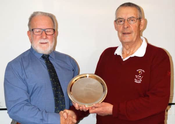 Bill Laing (right) presenting the 2017 captain Ian McKenzie with a commemorative silver plate for his term in office.