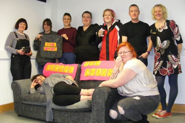 Artists and members of the Framework homeless project with their handiwork from the upholstery workshop. EMN-180127-133310001