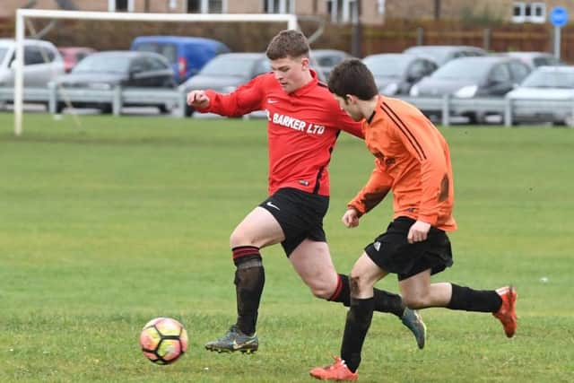 Coningsby Res (red) v Caythorpe (orange). Brandon Rylett (red), Kenny Miles (orange). EMN-180130-084925002