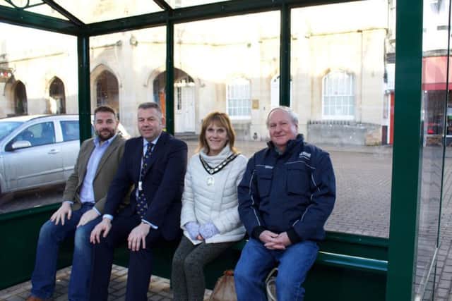 Trying out the new bus shelter in Sleaford Market Place. From left - Coun Richard Davies (LCC), Coun Richard Wright (NKDC Leader), Coun Jan Mathieson (Mayor of Sleaford) and Coun Anthony Brand (Deputy Mayor of Sleaford). EMN-180125-124428001