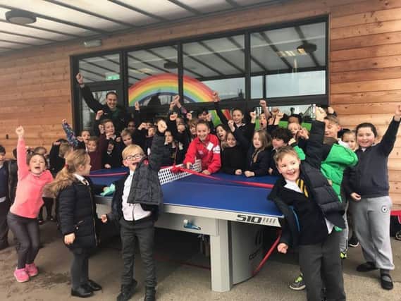 England U15 International table tennis player Darcie Proud cuts the ribbon of Hogsthorpe Primary Academy's new games equipment. ANL-180126-163609001