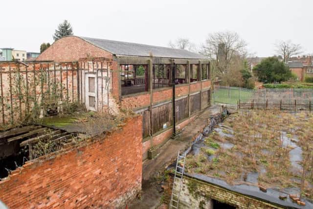 Looking out across the cellars to the old metal framed building which will be the site of the proposed cinema. EMN-180127-133429001