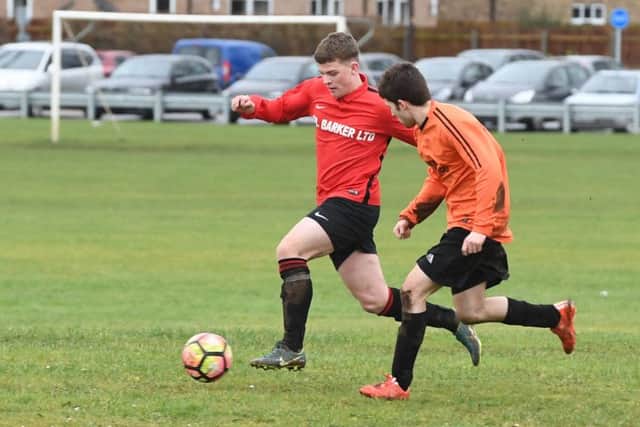Coningsby Res (red) v Caythorpe (orange). Brandon Rylett (red), Kenny Miles (orange).