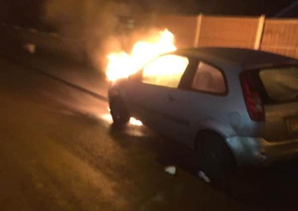 The car on fire in Billinghay. Photo: Cameron Johnson and David Clapham.  EMN-180129-093444001