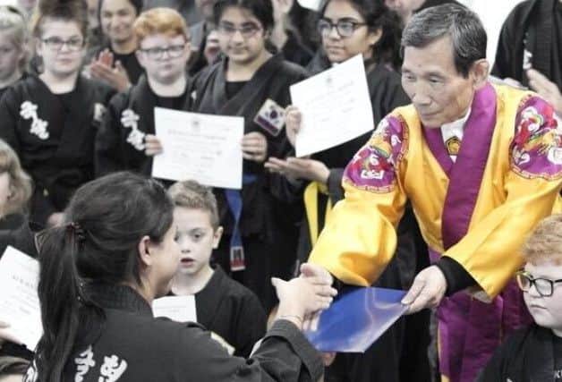 Rysian Boyall is pictured with Grandmaster In Hyuk Suh.