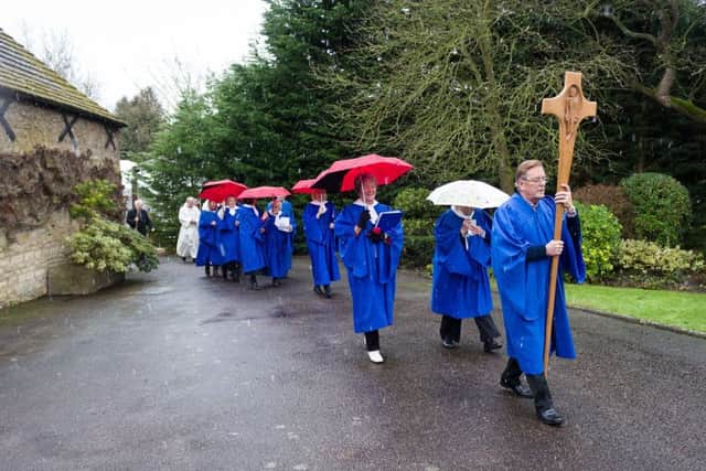 The choir leads the procession to the church. EMN-180202-131438001