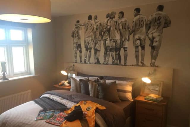 A bedroom in one of the showrooms is laid out with signs of Boston United. The window looks out onto where the stadium will be built.
