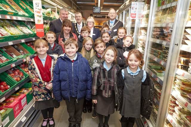 Pupils from the Sutton on Sea Primary School with Dave Pearson (head), Coun Tony Mee (Mayor), Jayne Snowden (Store Manager) and Coun Steve Palmer (Deputy Mayor). Photo: Les Gibbon.