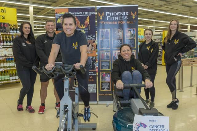 Staff from Pheonix Fitness gym in Skegness take part in the 'row and spin-a-thon' in Tesco. Photos by Mark Bensen.