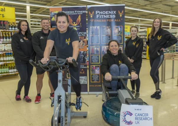 Staff from Pheonix Fitness gym in Skegness take part in the 'row and spin-a-thon' in Tesco. Photos by  Mark Bensen.