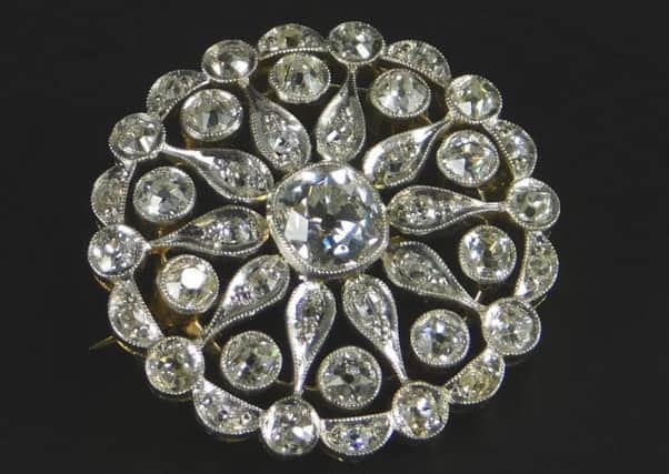 Inset: Diamond brooch which fetched a pretty price of Â£1,200.