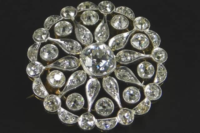 Inset: Diamond brooch which fetched a pretty price of £1,200.