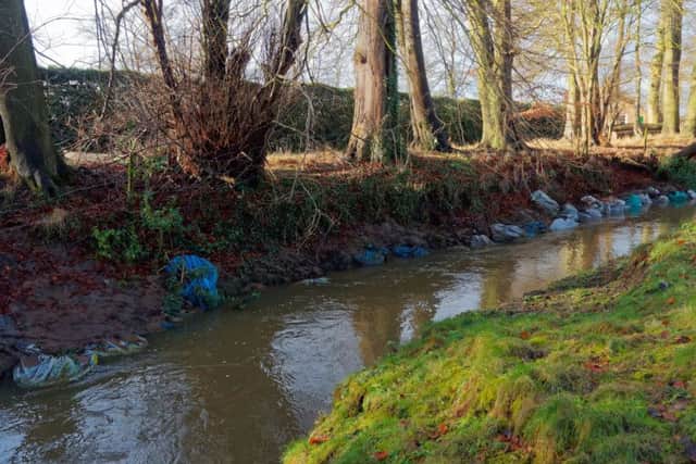 Unsightly sandbags in the River Rase proving a concern for local resident.