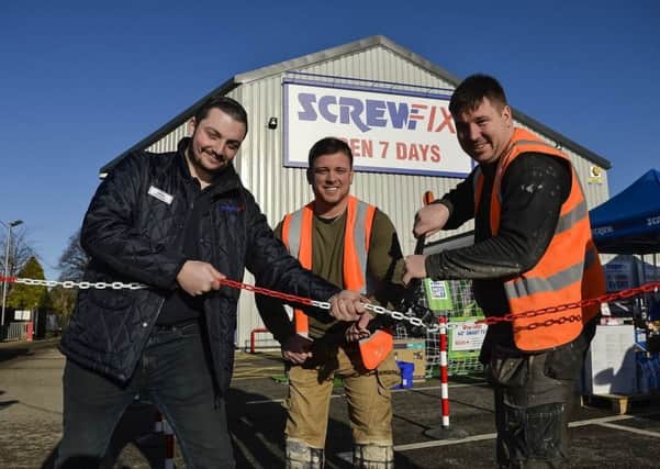 Cutting the chain to officially open the new Screwfix store is Jamie Griffiths (Manager), Stuart Mawson (SP Joinery) and Patrick Lynch (SP Joinery).