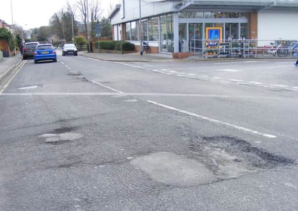 The pitted surface on Mareham Lane, near Aldi in Sleaford has frustrated Coun Adrian Snookes. EMN-180902-180424001