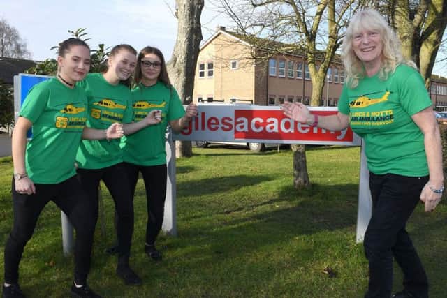 Giles Academy teacher, Kath Wood is going to run her first marathon to raise money for Air Ambulance, pictured with fundraising helpers. L-R Leah Ardron 18, Megan Knight 17, Hollie Baggaley 18, Kath Wood. EMN-180702-091433001