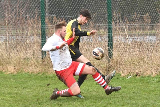 Wyberton Reserves (yellow) v Skegness Town Reserves (white). Jordon Foley (yellow), Aidan Smith (white).