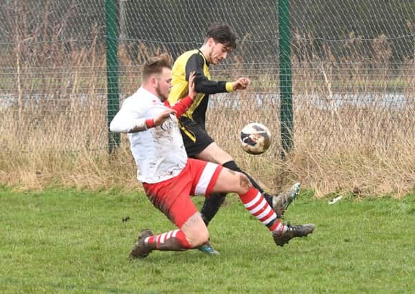 Wyberton Reserves (yellow) v Skegness Town Reserves (white). Jordon Foley (yellow), Aidan Smith (white).