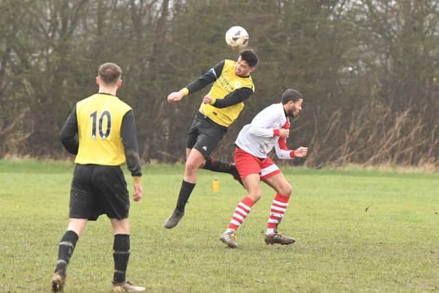 Wyberton Reserves (yellow) v Skegness Town Reserves (white). Scott Dawson (yellow), Tyler Bob (white).