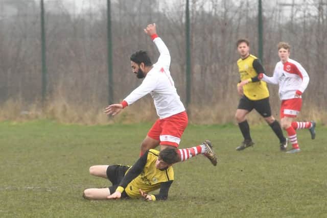 Wyberton Reserves (yellow) v Skegness Town Reserves (white). Jordon Foley (yellow), Lucky Singh (white).