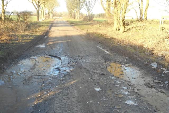 Potholes on the road betwwen Aswardby and Harrington. ANL-181202-133452001