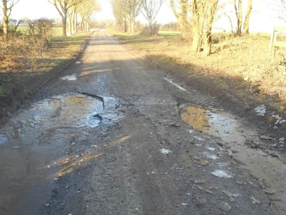 Potholes on the road betwwen Aswardby and Harrington. ANL-181202-133452001