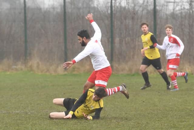 Wyberton Reserves (yellow) v Skegness Town Reserves (white). Jordon Foley (yellow), Lucky Singh (white).