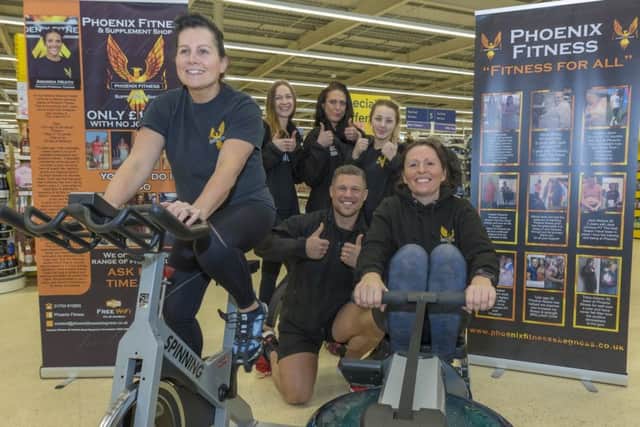 Staff from Pheonix Fitness gym in Skegness take part in the 'row and spin-a-thon' in Tesco. Photos by Mark Bensen.