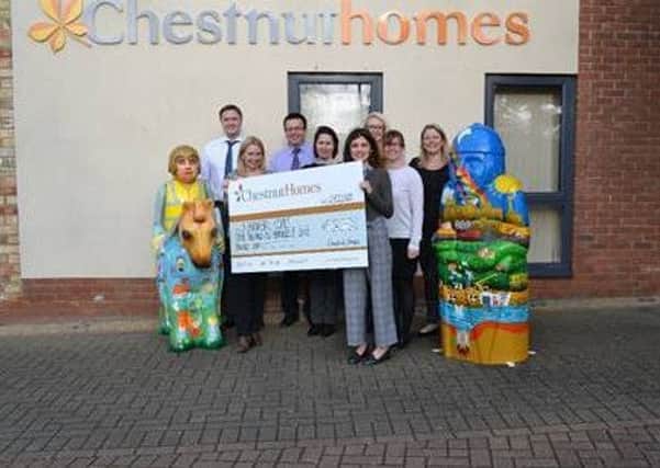 Staff from Chestnut Homes pictured with Ella Beale, Community Fundraiser for St Barnabas EMN-180213-120324001