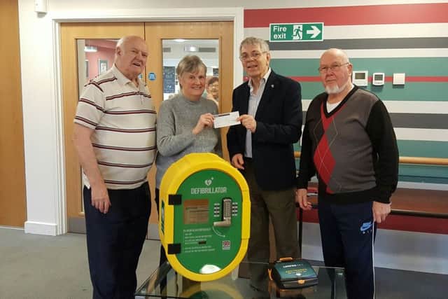 June Robinson, Treasurer of the Barratt Court Residents Association presenting a cheque for Â£1500 to Rotarian Norman Prime with Len Smith, Vice Chair of the Residents Association on the left and, right, Roy Palmer, chairman of the Residents Association.