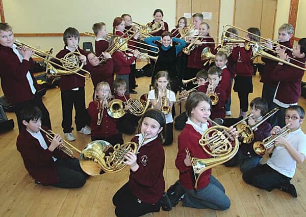 Emma Wilcox from Lincolnshire Music Services is pictured with Year Five and Six pupils from Hogsthorpe Primary School 10 years ago.