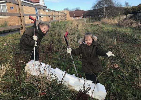 Maisie and Rebecca  Wyer who were out with their mum, Karen, over the holidays cleaning up The Meadows estate in Skegness. ANL-180219-161359001