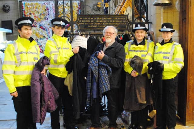 Churchwarden Bob Tamberlin accepts a delivery of warm winter coats from Boston Police Cadets, pictured, from left, Section Leader Stephen Covell, Cadet Ryan Tittershill, Bob, Cadet Lauren Gamble and Cadet Holly King. EMN-180215-110339001