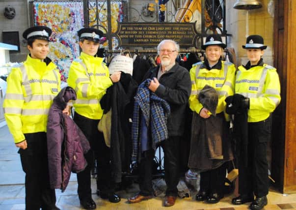 Churchwarden Bob Tamberlin accepts a delivery of warm winter coats from Boston Police Cadets, pictured, from left, Section Leader Stephen Covell, Cadet Ryan Tittershill, Bob, Cadet Lauren Gamble and Cadet Holly King. EMN-180215-110339001