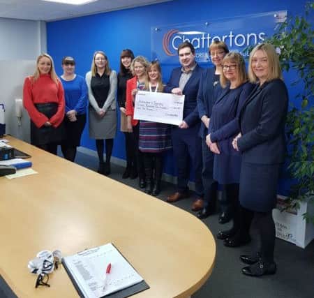 Staff presenting the cheque to representatives from the Alzheimer's Society.