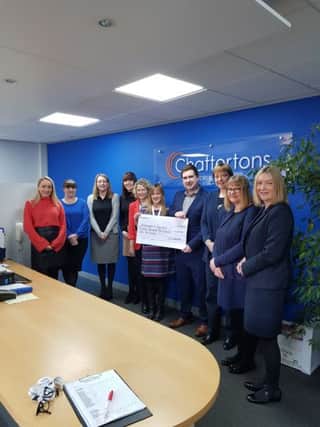 Staff presenting the cheque to representatives from the Alzheimer's Society.