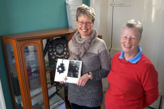 Nicola Marshall and Rase heritage chairman Hazel Barnard with the cap badge and photo of Nicola's grandfather Robert Fillingham EMN-180219-080818001