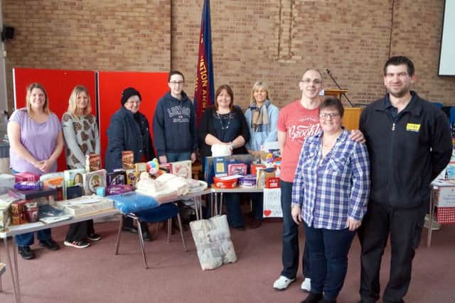 Lizzie and David Burke, right, with Richard Spence from LIVES and some of the many people who helped at the fundraising event EMN-180226-074821001