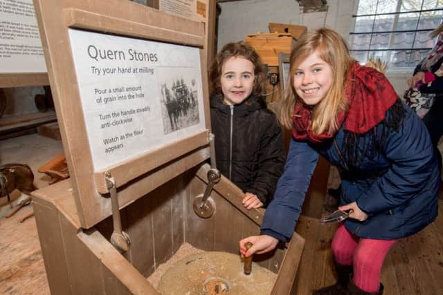 Millie Bland age 9 and Elizabeth Bland 5 have a go at hand milling EMN-180226-172618001