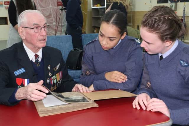 RAF cadet sergeants Ella-May Hansford and Allesandra Hinton Shereston listen to Second World War veteran Harry Parkins. Image supplied.