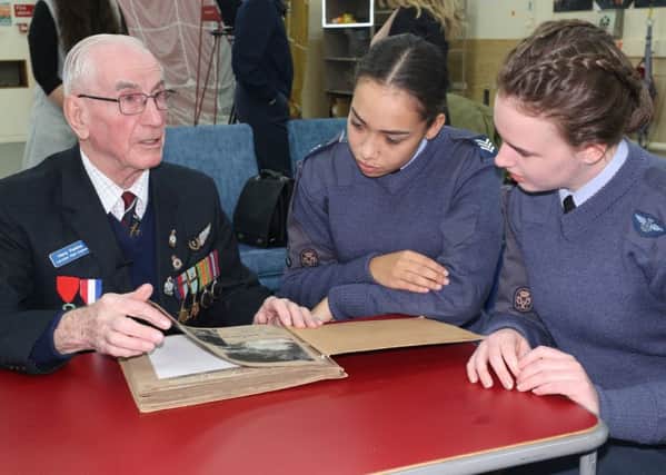 RAF cadet sergeants Ella-May Hansford and Allesandra Hinton Shereston listen to Second World War veteran Harry Parkins. Image supplied.