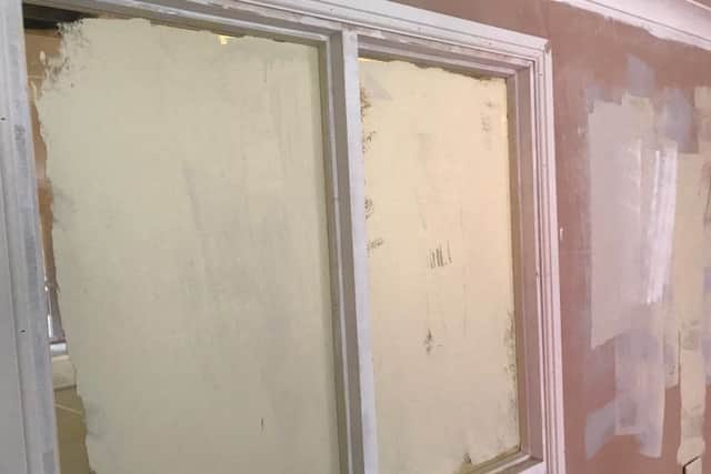 Painted out. Vandals actually set to with brushes or rollers on this window. EMN-180222-145708001