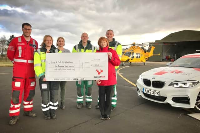 Cadwell Park events co-ordinator, Elaine Nutbrown, (pictured right), presents a cheque to Lincolnshire Air Ambulance Trust.