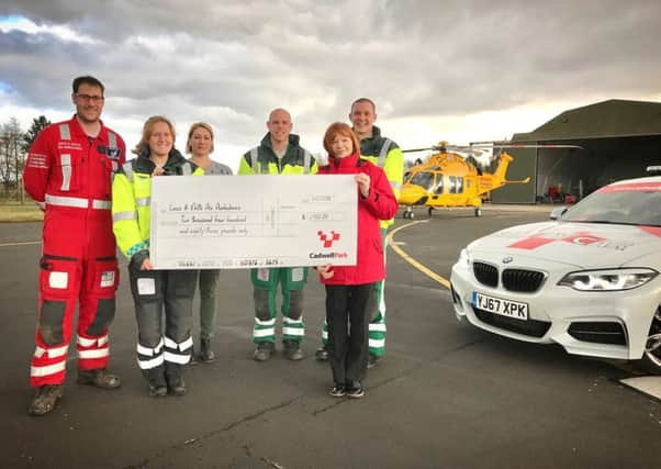 Cadwell Park events co-ordinator, Elaine Nutbrown, (pictured right), presents a cheque to Lincolnshire Air Ambulance Trust.